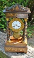 French column clock in rosewood with inlays, 19th century. Turned columns with bases and ...