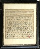 Name cloth from 
1880. 
Cross-stitch 
embroidery with 
numbers and the 
alphabet in a 
black wooden 
...