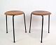 A set of teak stools with a black frame, designed by Arne Jacobsen and manufactured by Fritz ...