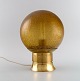 Bergboms, Sweden. Table lamp in brass and amber colored art glass. 1970s.Measures: 25.5 x 19.5 ...