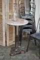 Old French cafe table with fine cast iron base and marble top. The table has a really nice ...