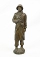 Soldier figure of patinated metal from around the 1940s. The figure also has an unknown ...