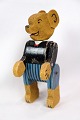 A toy teddy bear made of wood which has acquired a patina over the years produced approx. year ...