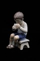Bing & Grondahl porcelain figurine of a little boy drinking milk.H:13cm. Decoration number: ...