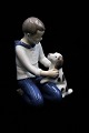 Bing & Grondahl 
porcelain 
figurine of a 
boy with a dog. 

Decoration 
number: B&G 
2334. 1.sort. 
...