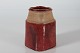 Herman A. KählerSlightly conic and asymmetric squarevase with red glaze. The neck is left ...