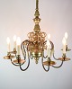 Church chandelier with eight arms in a French style of brass from around the 1920s. The lamp can ...