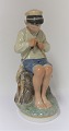 Royal Copenhagen. Porcelain figure. Seated boy in colors. Model 905. Height 19 cm. (1 quality)