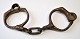 A pair of 
handcuffs, 19th 
century 
Denmark. Cast 
iron. L. 24 cm.
Provenance: 
Fiirgaard 
locks, ...