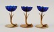 Gunnar Ander for Ystad Metall. Two candlesticks in brass and blue art glass shaped like ...