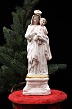 Decorative, old porcelain Madonna figure of the Virgin Mary with the baby Jesus. Height: 20.5 cm.