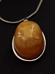 Amber pendant 2.5 x 3.4 cm. with sterling silver mounting and chain 42 cm. Item No. 519072