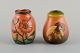 Ipsens Denmark. 
Two small vases 
in hand-painted 
glazed ceramic 
decorated with 
flowers and ...