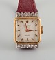 Rolex, Precision. 18 carat gold ladies' wristwatch set with twelve diamonds.Approx. ...
