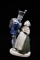 Royal 
Copenhagen 
porcelain 
figure of a 
soldier with an 
elderly woman. 
Decoration 
number: RC ...