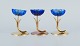 Gunnar Ander for Ystad Metall. Two candlesticks in brass and blue art glass shaped like ...