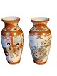 Pair of 
Japanese Kutani 
vases decorated 
in orange and 
gold panels 
with motifs of 
garden scenes 
...