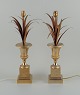 Charles & Fils, France.A pair of table lamps in patinated metal, designed with palm leaves in ...