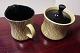 Creamjug and 
sugar/marmelade 
bassin made of 
porcelain
Yellow with a 
black lid, and 
with black ...