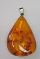 Polished amber with seeds, with pendant. Ca. 5 cm.