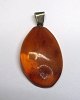 Polished amber pendant, Denmark. L .: 3,5 cm. Weight: 3.3 grams. With silver eyelet.
