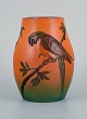Ipsen's, 
Denmark. Vase 
decorated with 
parrot and 
glaze in shades 
of 
orange-green.
Model ...