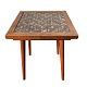 Small square table in teak veneer with slightly inclined legs in solid teak wood. Tiles in a ...