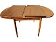 Dining table in rosewood veneer with two flaps and two additional plates. Shows some traces of ...