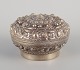 Chinese silversmith. Lidded jar richly decorated in relief with flowers and ornaments.China ...