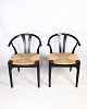 A pair of chairs in Nordic design with natural wicker seat made in black lacquered beech wood by ...