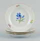Meissen, Germany. Four porcelain plates hand-painted with various floral motifs and gold ...