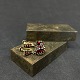 Length 2.5 cm.Fine old ear screws in gilded brass with ground garnets.They are from the ...