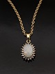 14 carat pendant 0.9 x 1.3 cm. with opal surrounded by clear zircons and 14 carat chain 43.5 cm. ...
