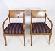 A pair of Danish Empire style hand-polished mahogany armchairs with striped fabric from around ...