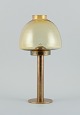Hans-Agne Jakobsson (1919-2009), candlestick in brass and smoked glass.Approx. 1970s.In ...