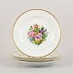 Bing & 
Grøndahl, four 
dinner plates 
in porcelain 
hand-painted 
with polychrome 
flowers and 
gold ...