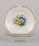 Bing & 
Grøndahl, four 
deep plates in 
porcelain 
hand-painted 
with polychrome 
flowers and 
gold ...