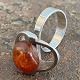 Sculptural ring of sterling silver with polished amber. Internal dimensions 17.5 mm. Stamped ...