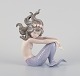Lladro, Spain, 
handmade 
porcelain 
figurine of a 
sitting 
mermaid.
Model 1413.
From the ...