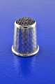 Silver thimble 
with red glass 
stone. Stamped 
sterling H.J. 
from 
silversmith 
Hans Jensen & 
co., ...