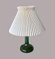 Table lamp 
1970's
Lamp base: 
Kastrup-
Holmegård
Lamp shade: Le 
Klint
Base: Green 
glass
Shade: ...