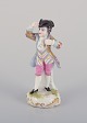 Meissen, Germany, porcelain figurine of a young man in elegant attire. Hand-painted in ...