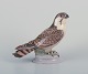 Dahl Jensen for Bing & Grøndahl. Porcelain figurine of a sitting peregrine falcon.Dating from ...