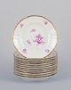 Bing & 
Grøndahl, 
Denmark. A set 
of twelve small 
plates with 
flower 
decorations in 
purple and ...