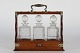 Old English tantalusMade of oak with 3 decantersHeight 34 cmLength 36.5 cmDepth 13 ...