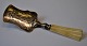 Small silver spatula with rococo decoration of a woman churning butter, 19th century. Bone ...