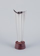 Tapio Wirkkala 
(1915-1985), 
Finnish 
silversmith. 
Modernist 
silver vase on 
a rosewood ...
