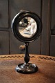 Decorative, 
small table 
mirror on a 
black wooden 
base from 
around 1900. 
H:25,5cm. 
Dia.:13,5cm.