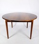 Teak dining table with built-in additional plate and round legs of Danish design from around the ...