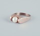 Danish goldsmith, 14 karat gold ring adorned with a cultured pearl. Modernist design.From the ...